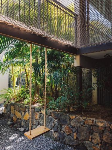 a porch with a swing in front of a building at Domaine du Cap Sauvage in Saint-Joseph