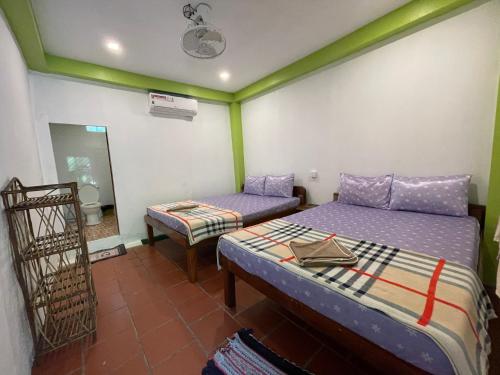 a room with two beds and a mirror at Villa Koh Rong in Koh Rong Island