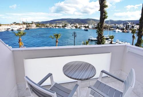 a balcony with chairs and a view of a harbor at Kosta Palace in Kos Town