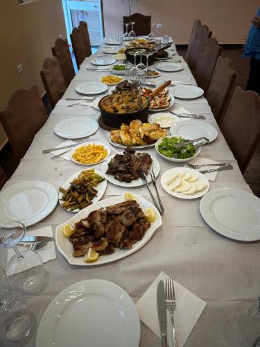 a long table with plates of food on it at Hotel Rubin in Rubik
