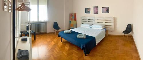 a bedroom with a bed and a wooden floor at Vista Duomo Ravenna City Center Apartment in Ravenna