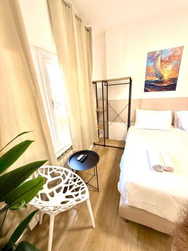 a bedroom with a bed and a table and a chair at Aju Hillel 14 in Jerusalem