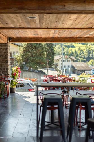 a patio with chairs and a table and tables and chairs at Hébergement l'Escale - Le Châble - Verbier in Le Châble