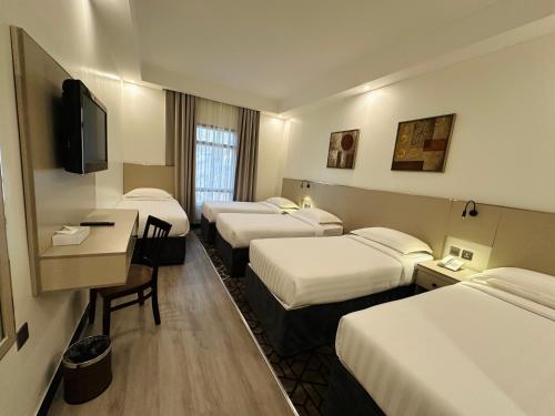 Una cama o camas en una habitación de Saif Al Majd Hotel