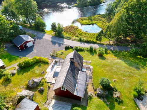 an aerial view of a house and a river at Knaggelid Guest Houses in Svängsta