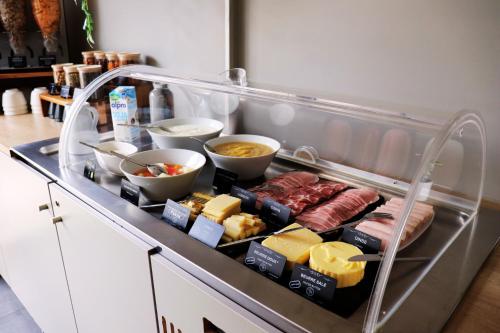 a drawer filled with different types of food on a counter at Kyriad Lyon Est Stadium Eurexpo Meyzieu in Meyzieu