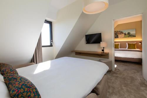 Postel nebo postele na pokoji v ubytování Hôtel Terra Vinum