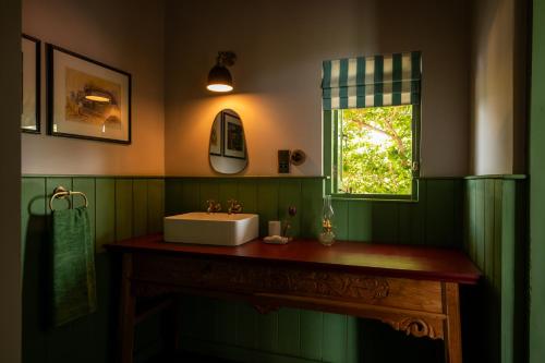 Un baño con lavabo y ventana. en Peacock Hill Sigiriya, en Dambulla