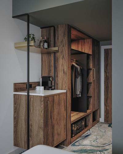 a bathroom with a wooden cabinet with a sink at Le Méridien Paris Arc De Triomphe in Paris