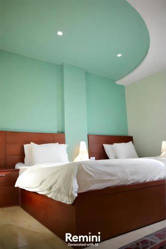 a bedroom with a large bed with white sheets at Pyramids Grand View Hotel in Cairo