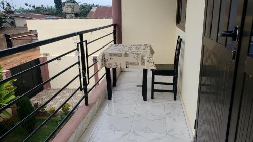 a table and a chair on a balcony at Edelweiss in Porto-Novo