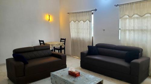 a living room with two couches and a table at Edelweiss in Porto-Novo