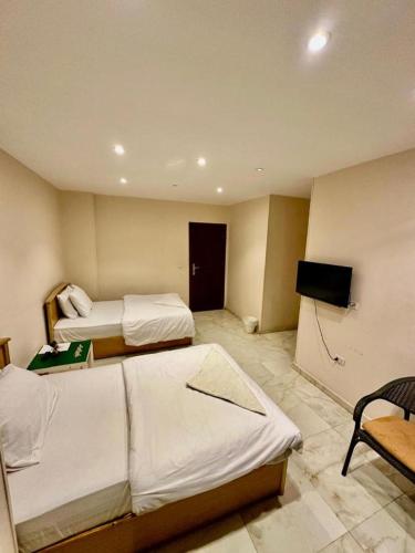 a hotel room with two beds and a television at Pyramids Grand View Hotel in Cairo