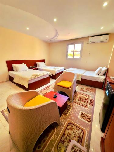 a hotel room with two beds and a tv at Pyramids Grand View Hotel in Cairo