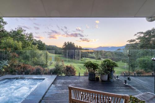 a patio with a bench and a swimming pool at Ralphies Villa 2 bed 2 bath with Valley views in Kangaroo Valley