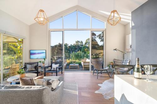 a living room with a large glass window at Ralphies Villa 2 bed 2 bath with Valley views in Kangaroo Valley