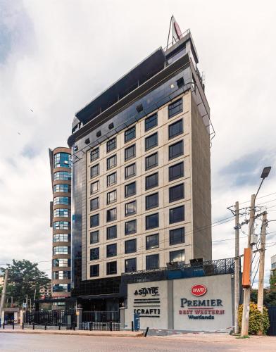 a large white building with a sign in front of it at Best Western Premier Westlands in Nairobi