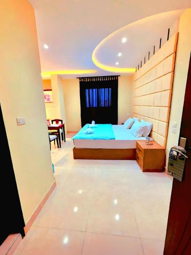 a bedroom with a bed and a dining room at Pyramids Grand View Hotel in Cairo