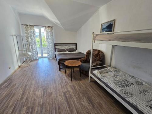 a room with two bunk beds and a table at Гостьовий будинок Осокорки in Kyiv