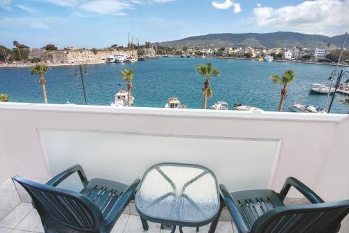 a balcony with chairs and a view of a marina at Kosta Palace in Kos Town