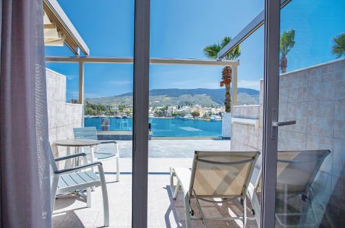 a balcony with chairs and a table and a view of the city at Kosta Palace in Kos Town