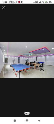 a room with two tables and a ping pong table at HOTEL SQUARE INN Cosmopolitan in Bengaluru
