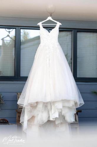 a white wedding dress hanging on a rack at LIONHEART LARGE LUXURY ACCESSIBLE LODGE - Sleeps 12 ,Dog Friendly,Near Sherwood Forest at Fairview Farm Nottingham great for Family Gatherings ,Groups ,Parties in Nottingham
