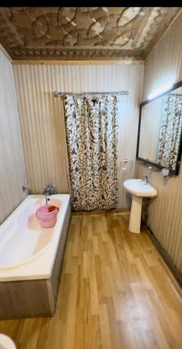 a bathroom with a bath tub and a sink at Houseboat young Minar in Srinagar