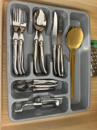 a tray filled with utensils and silverware at Appartement Rabat Agdal in Oulad Akkou