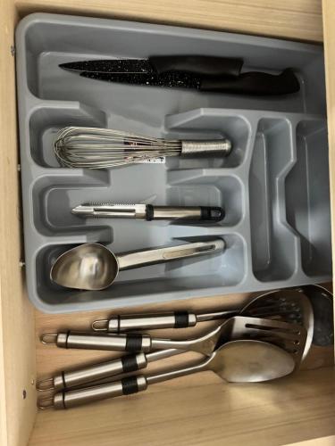 a tray with utensils in a drawer at Appartement Rabat Agdal in Oulad Akkou