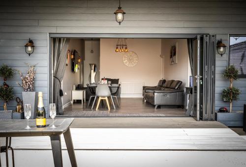 a living room with a couch and a table at LIONHEART LARGE LUXURY ACCESSIBLE LODGE - Sleeps 12 ,Dog Friendly,Near Sherwood Forest at Fairview Farm Nottingham great for Family Gatherings ,Groups ,Parties in Nottingham