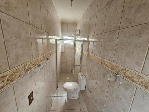 a bathroom with a toilet and a walk in shower at Hotel vista alegre in Itapeva