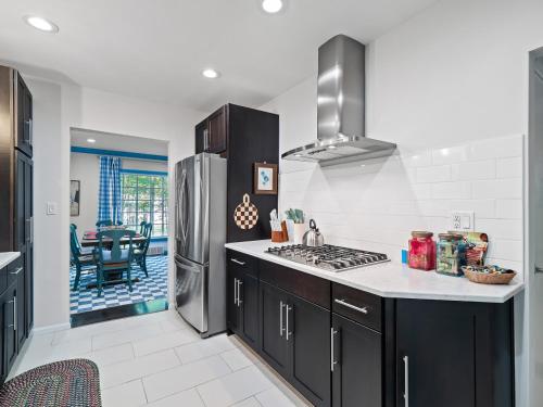 a kitchen with black cabinets and a stainless steel refrigerator at Ellendale Rd Moreland Hills 