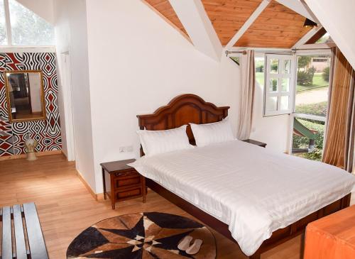 Postel nebo postele na pokoji v ubytování Chez Drocella Eglantine Lodge