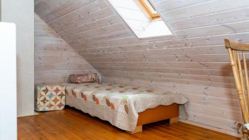 a small room with a bed and a skylight at Mere Holiday Home in Yarve-Keskranna
