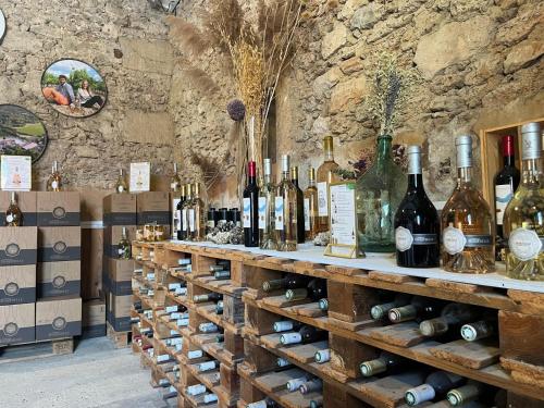 a bunch of bottles of wine on display in a store at Maison du Berger - Vignoble Château Barbebelle, Rognes, maison provençale avec jardin partagé et parking - proche d'Aix-en-Provence - 5 personnes in Rognes