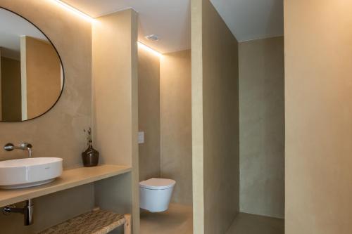 a bathroom with a sink and a toilet at Casa do Regadio in Zambujeira do Mar