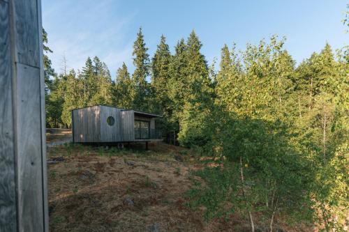 a small cabin in the woods next to trees at Bungalows da Travanca in Arcos de Valdevez