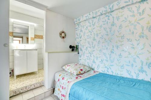 a small bedroom with a bed and a mirror at Le Clos Rilda en Bounet in Villefranche-de-Lauragais
