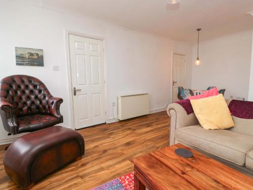 a living room with a couch and a chair at Duncan Square in Whitehaven