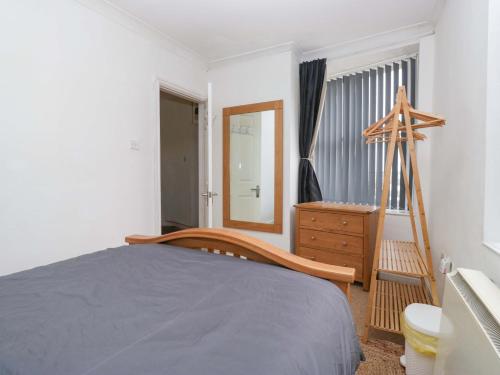 a bedroom with a bed and a mirror and a dresser at Duncan Square in Whitehaven
