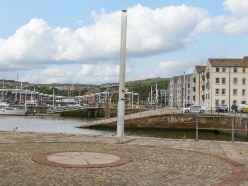 a bridge over a body of water next to a city at Duncan Square in Whitehaven