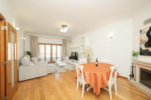 a living room with a table and a couch at Odivelas Premium By Hosty in Odivelas