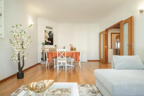 a living room with a table and a couch at Odivelas Premium By Hosty in Odivelas