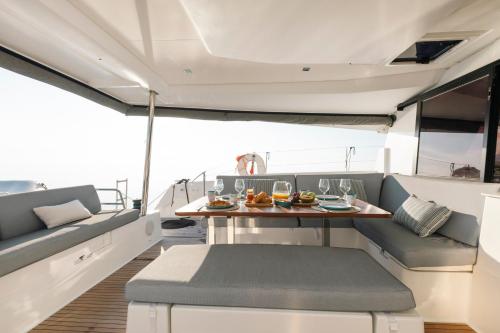 a dining area on a boat with a table at Dione Catamaran in Thessaloniki
