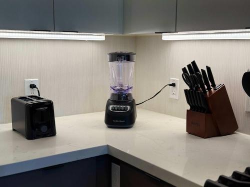 a blender sitting on a counter next to a toaster at Sunlit Retreat 10 Min from Disneyland With Pool & GYM in Tustin