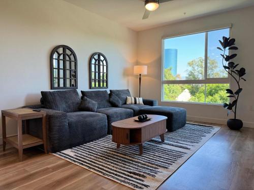 a living room with a blue couch and a table at Sunlit Retreat 10 Min from Disneyland With Pool & GYM in Tustin