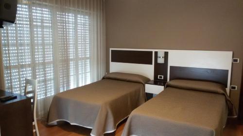 מיטה או מיטות בחדר ב-Hotel El Millón