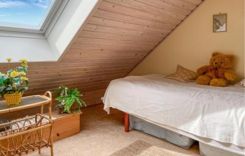 a bedroom with a bed with a teddy bear on it at 2 Bedroom Gorgeous Home In Tranekær in Tranekær