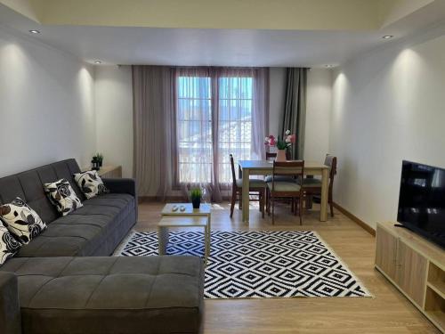 a living room with a couch and a table at One bedroom old town tawaya Sahel hashish in Hurghada